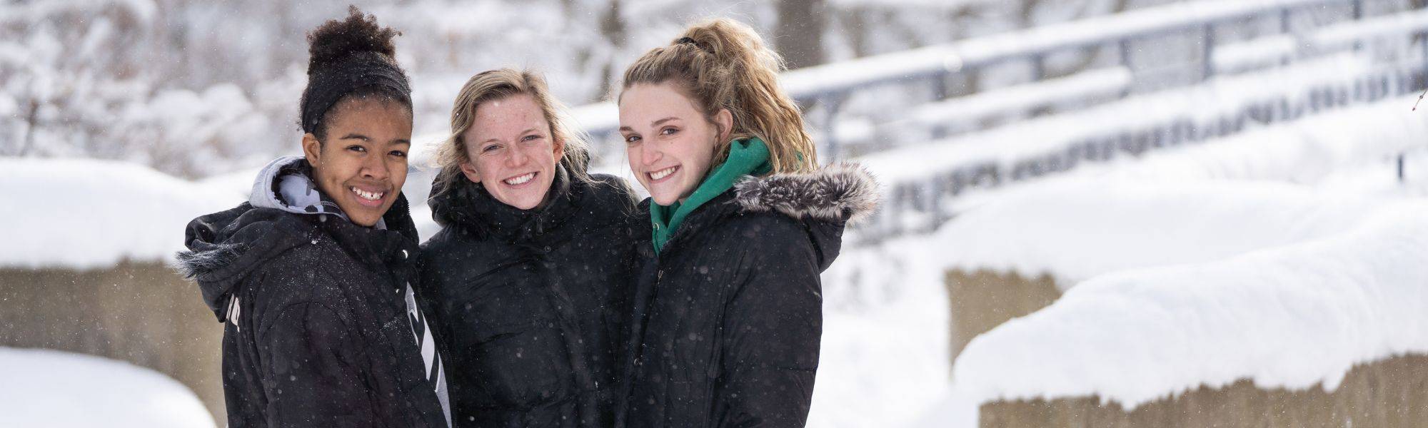 Students posing for a picture in the snow